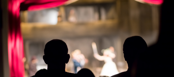 people watch a show at a theater